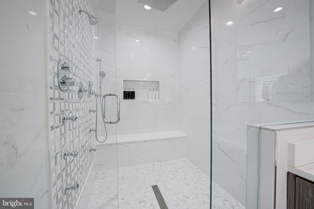 bathroom featuring recessed lighting and a marble finish shower