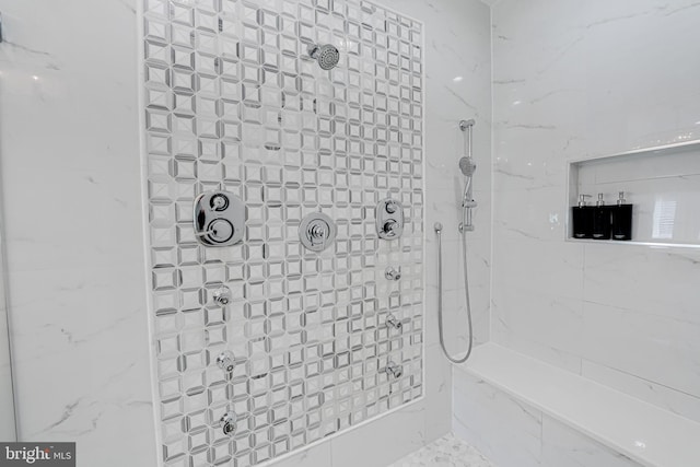 bathroom with a tile shower