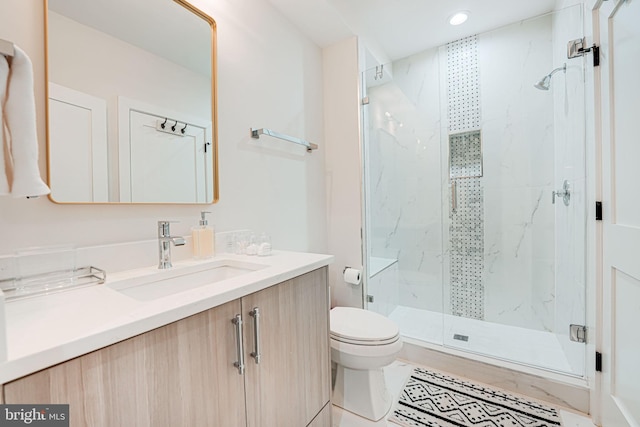 bathroom with a marble finish shower, toilet, and vanity