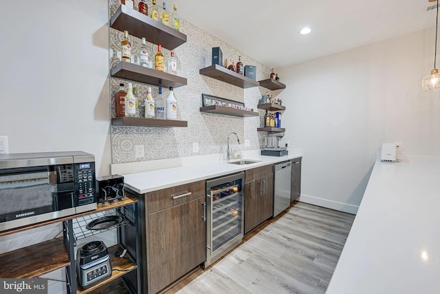 kitchen with wine cooler, appliances with stainless steel finishes, open shelves, and a sink