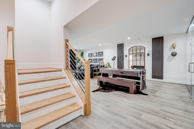 stairway with recessed lighting, baseboards, and wood finished floors