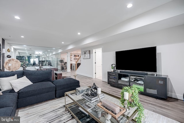 living room featuring recessed lighting, stairs, and wood finished floors