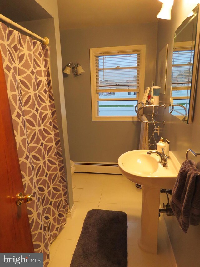 bathroom with baseboard heating and a shower with shower curtain