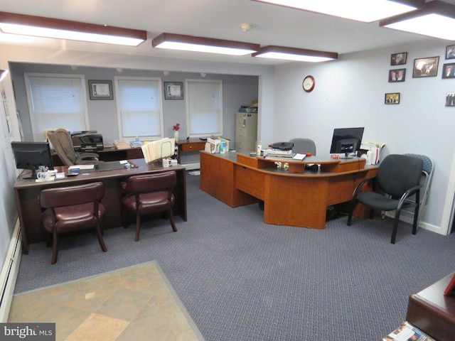 carpeted office space featuring baseboard heating