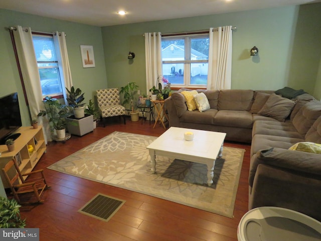 living area featuring a wealth of natural light, visible vents, recessed lighting, and wood finished floors