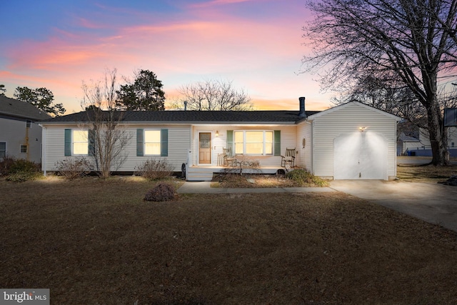 ranch-style home with a garage, driveway, and a lawn