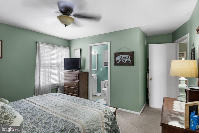 bedroom featuring ceiling fan, ensuite bath, carpet flooring, and baseboards