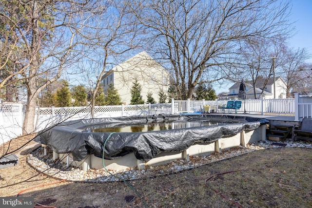 view of swimming pool with a fenced in pool and fence