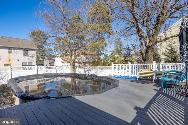 view of swimming pool featuring fence and a deck