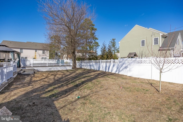 view of yard with a deck and fence private yard