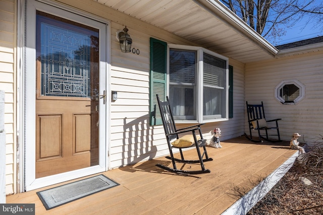 entrance to property featuring covered porch and visible vents