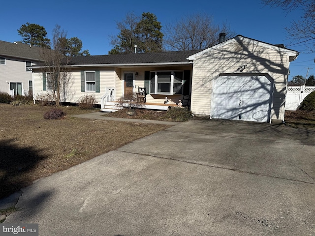 ranch-style house featuring driveway, an attached garage, and fence