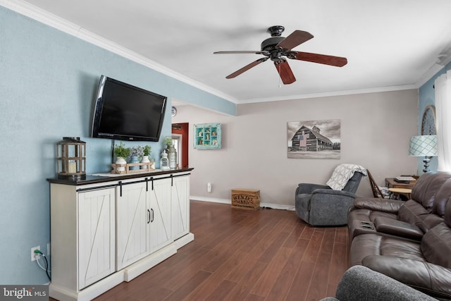 living area featuring baseboards, dark wood finished floors, a ceiling fan, and crown molding