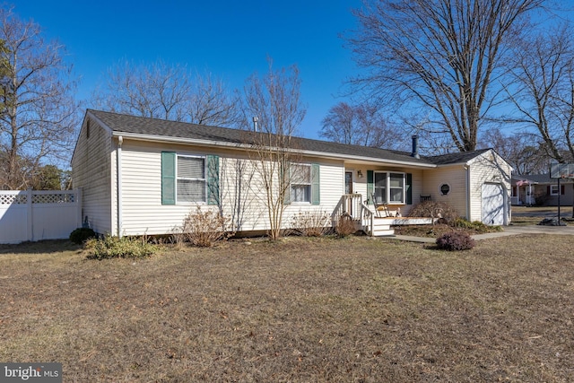 ranch-style house featuring a garage, a front lawn, and fence