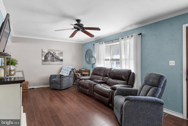 living room featuring dark wood-style flooring, a textured wall, ornamental molding, ceiling fan, and baseboards