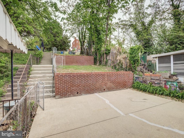 view of patio / terrace with stairway and fence