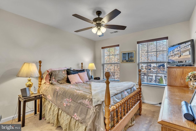 bedroom with carpet floors, visible vents, ceiling fan, and baseboards