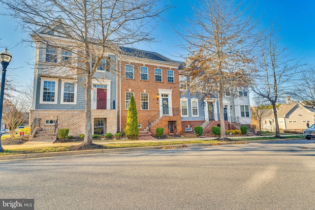 townhome / multi-family property with brick siding