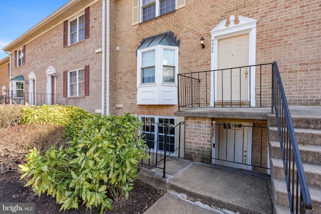 property entrance featuring brick siding