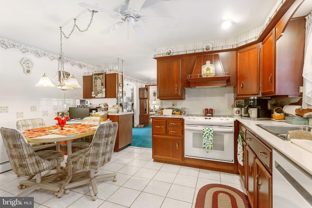 kitchen featuring white appliances, light tile patterned floors, brown cabinetry, wallpapered walls, and light countertops