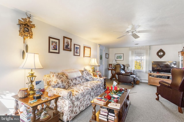 carpeted living area featuring baseboard heating and a ceiling fan