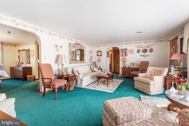 carpeted living room with arched walkways