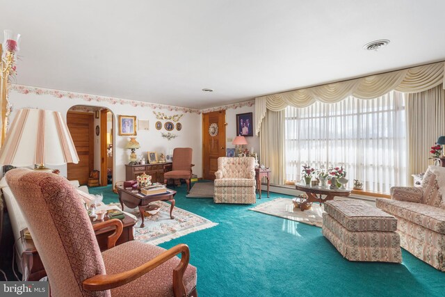 carpeted living room featuring visible vents, arched walkways, and a baseboard radiator