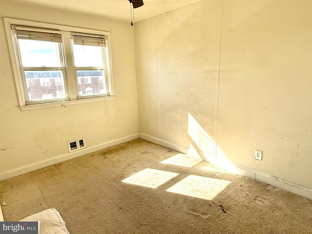 spare room featuring baseboards and visible vents