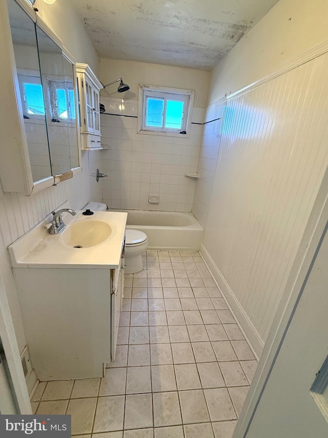 full bathroom with bathing tub / shower combination, vanity, toilet, and tile patterned floors