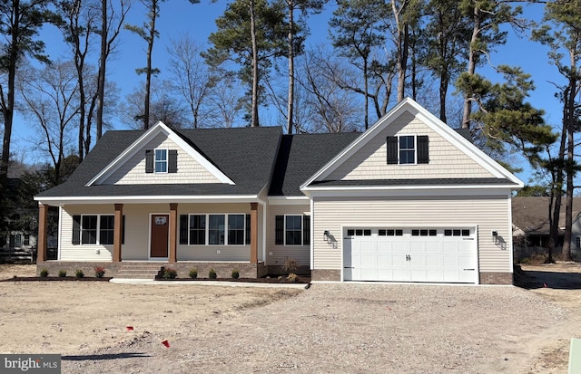 view of front of home with an attached garage, a porch, and driveway