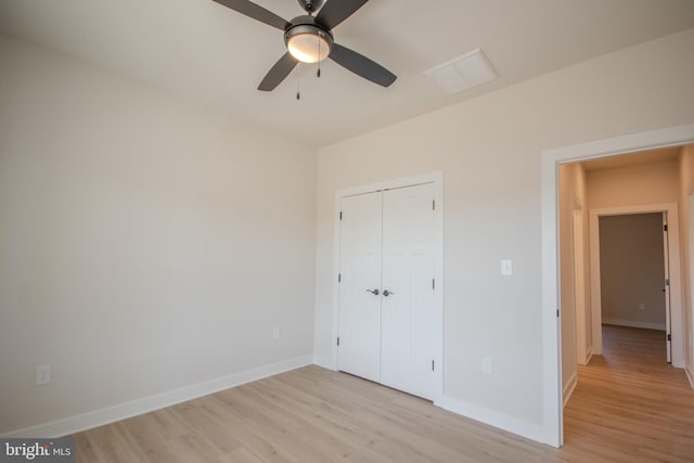 unfurnished bedroom with a closet, light wood-type flooring, and baseboards