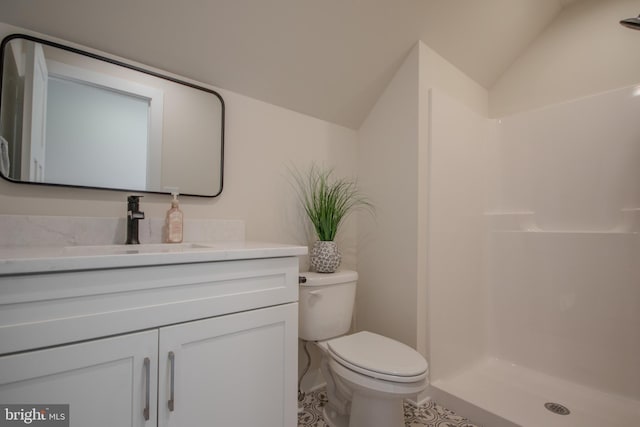 full bath with toilet, a shower stall, vanity, and vaulted ceiling