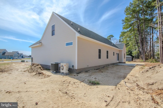 view of home's exterior with ac unit and central AC unit