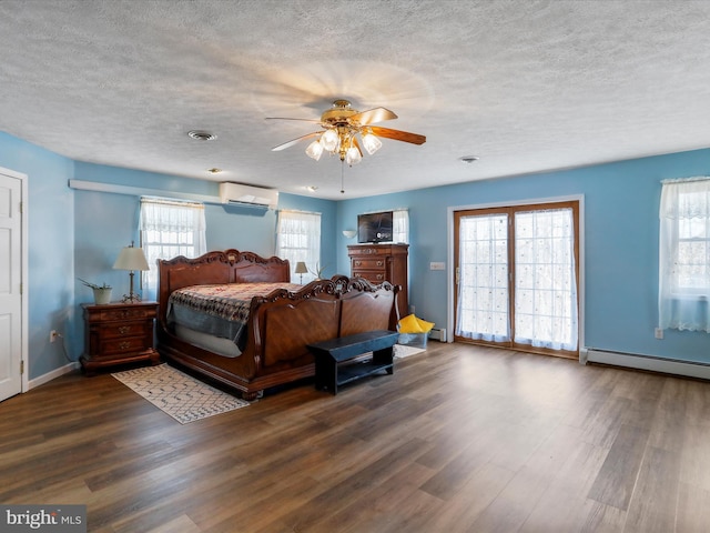 bedroom with dark wood finished floors, multiple windows, baseboard heating, and a wall mounted air conditioner