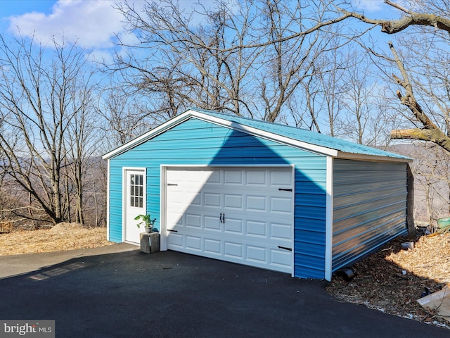 detached garage featuring driveway