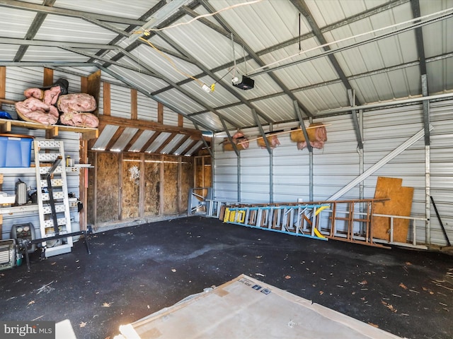 garage featuring metal wall and a garage door opener