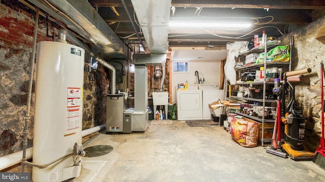 unfinished below grade area featuring gas water heater, a sink, and washer and clothes dryer