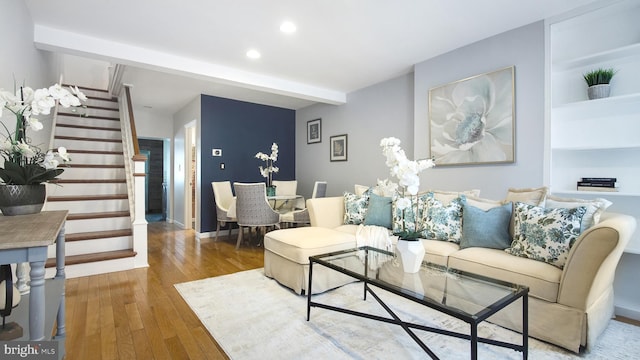 living area featuring stairs, wood-type flooring, baseboards, and recessed lighting