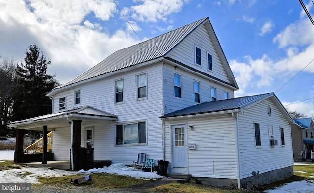 view of front of house with a porch and metal roof