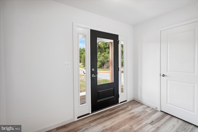 entryway with baseboards and light wood-type flooring