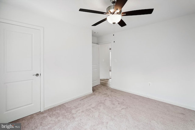 unfurnished bedroom with baseboards, carpet floors, and ceiling fan