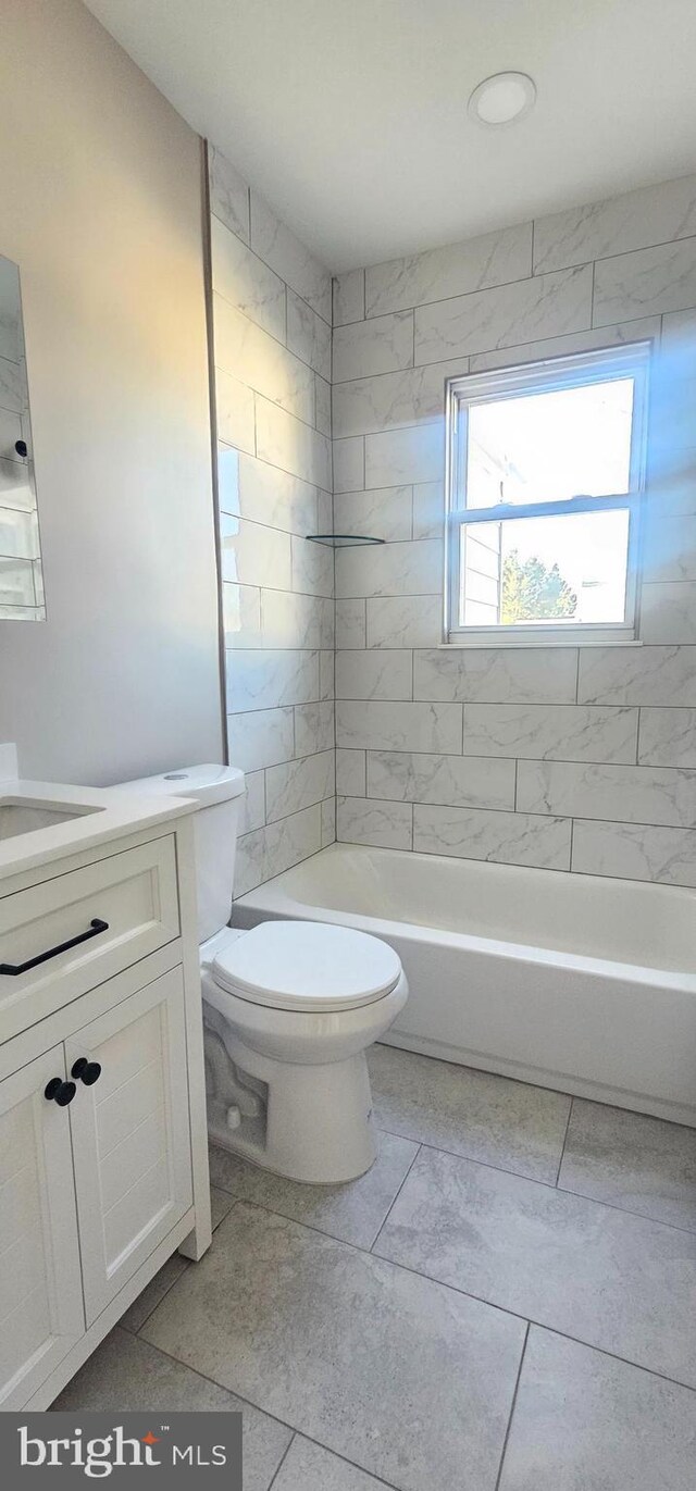 bathroom with vanity, toilet, and shower / bath combination