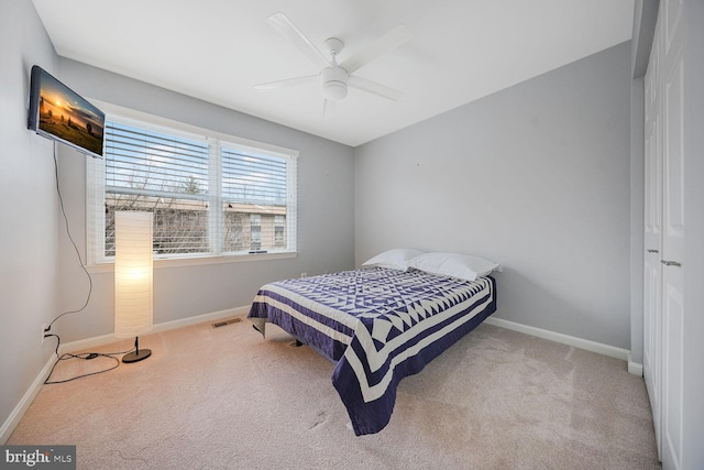 bedroom with a ceiling fan, visible vents, baseboards, and carpet floors