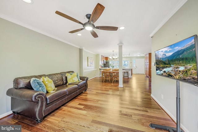 living room with recessed lighting, wood finished floors, baseboards, and ornamental molding