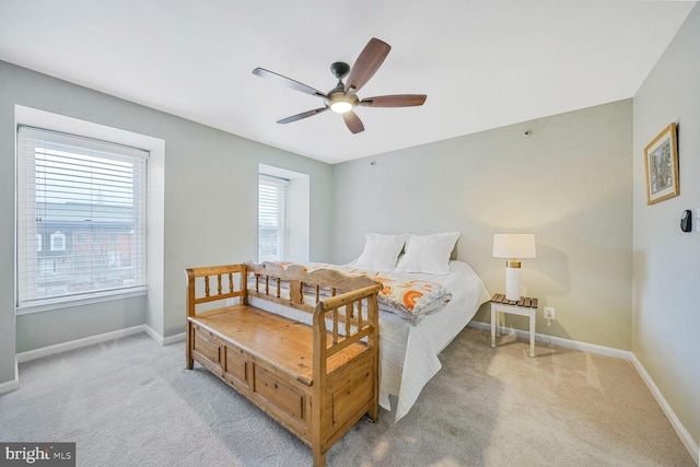 bedroom with baseboards, light carpet, and a ceiling fan