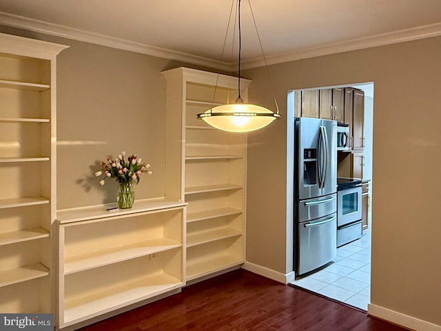 interior space with dark wood-type flooring, crown molding, and baseboards