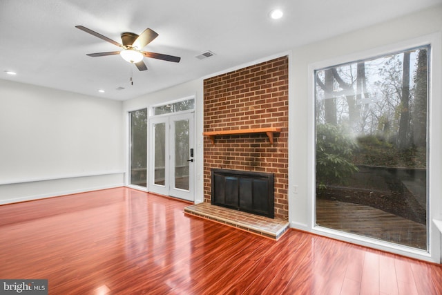 unfurnished living room featuring recessed lighting, a fireplace, wood finished floors, a ceiling fan, and visible vents