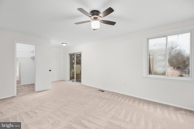 unfurnished bedroom featuring visible vents, baseboards, a spacious closet, a closet, and carpet