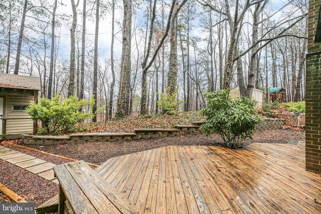 wooden terrace featuring an outdoor structure