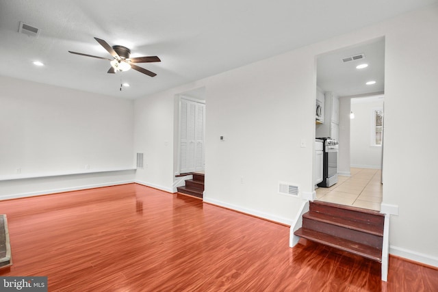 unfurnished living room featuring light wood-style floors, ceiling fan, and visible vents